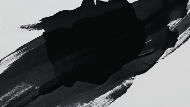 Black ink stroke across white surface during abstract creation process with subtle motion