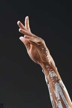 Elegant Hand and Arm Covered in Cracking White Clay