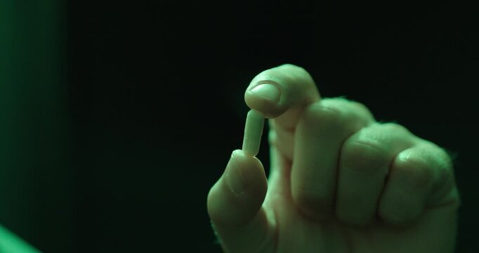 Holding a Pill Under Color Changing Party Lights. Ideal for nightlife, recreational drug awareness