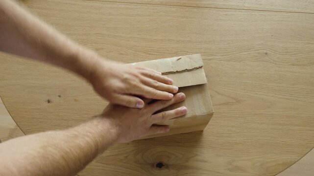 Packing a cardboard box securely with protective filler to prevent transport damage. Ideal for shipping, ecommerce, packaging, and logistics concepts.