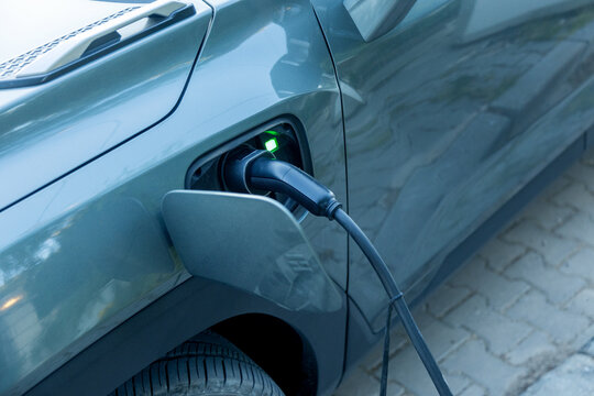 Electric car charging with plug-in cable close-up