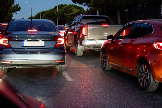 Evening traffic jam with cars stopped on urban road at night