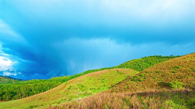 Majestic Rainbow above the Green grass mountain in Ranong. A peaceful rainforest landscape features a vibrant rainbow, creating an inspiring and picturesque view that symbolizes hope and renewal.