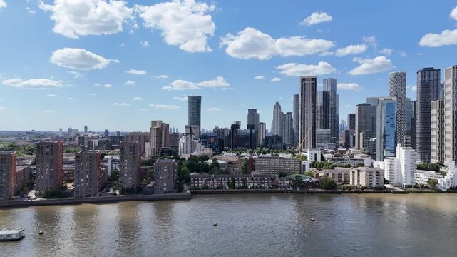 Fast aerial panorama of Canary Wharf financial district and South Dock skyline with River Thames in London, England