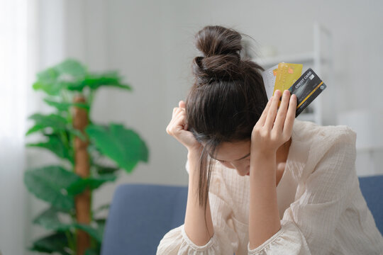 Credit card debt concept. Stressed woman holding multiple credit cards, facing financial problems and debt management. Credit, debt, finance, budgeting, payment