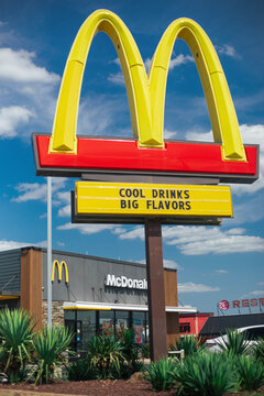 A McDonald's restaurant sign with golden arches and the text "Cool Drinks, Big Flavors" against a blue sky in Philadelphia, Pennsylvania, United States, on July 25, 2026.