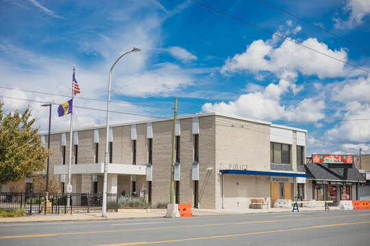 The 2nd District Police Station building facade with a boarded-up entrance and blue sky in Philadelphia, Pennsylvania, United States, July 25, 2026.