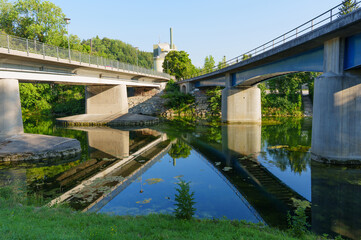 Fototapeta premium Modern Concrete Bridges Reflecting in Calm River in Schongau Germany