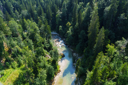 Aerial view of river flowing through green forest in Rottenbuch, Germany