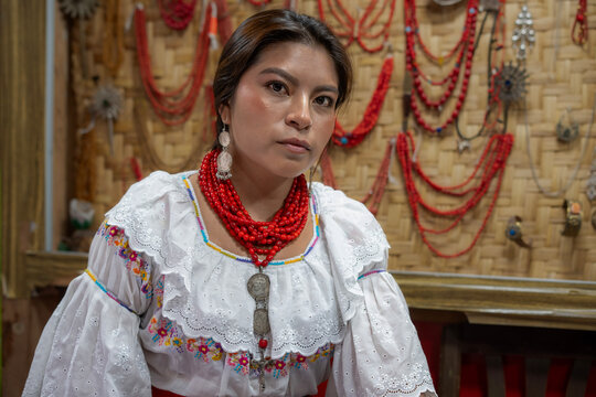 Indigenous woman in traditional dress reflected in mirror