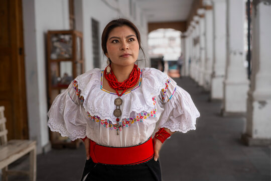 Woman in traditional dress with red beads and silver jewelry