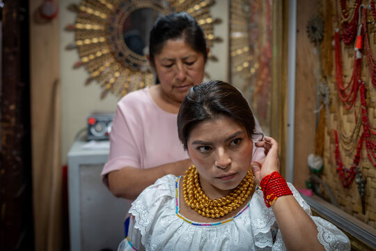 Indigenous woman wearing traditional beadwork and embroidered dress