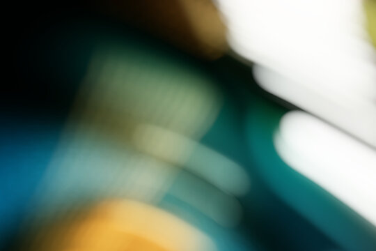 Abstract bokeh background, blurred teal and yellow lights with diagonal flare for creative overlay