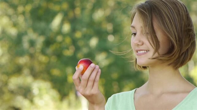 smiling beautiful young woman with peach