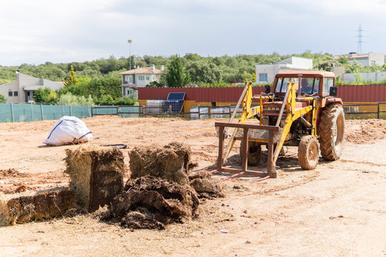 Tractor with front loader at rural construction site