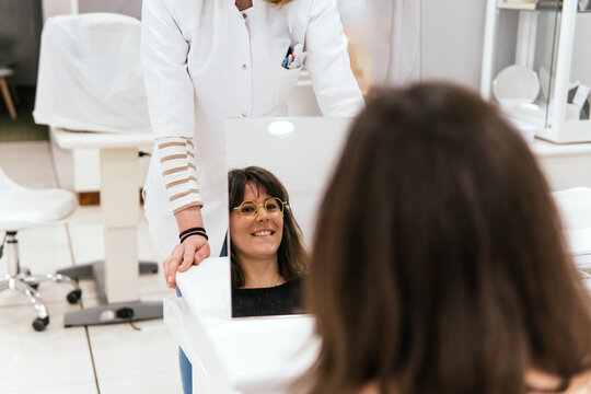 Woman try on eyeglasses during optician consultation