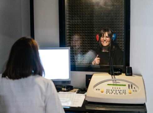 Woman wearing headphones during an optic hearing test