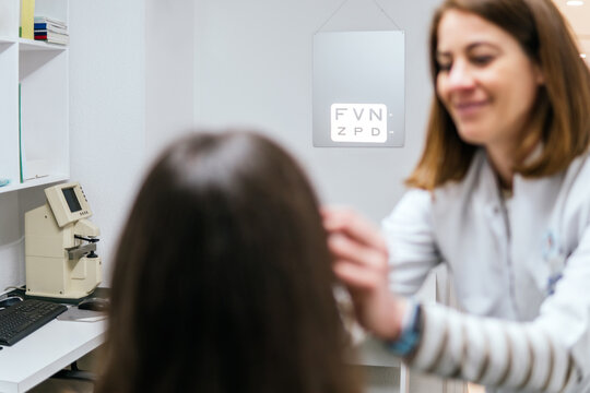 Optician examine woman during vision test in eye clinic