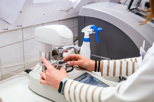 Woman adjust lens on optic equipment in laboratory
