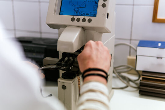 Woman operate optic instrument in clinical laboratory
