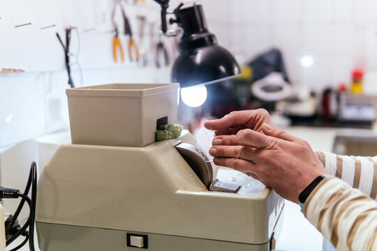 Woman adjust lens at optical workshop machine