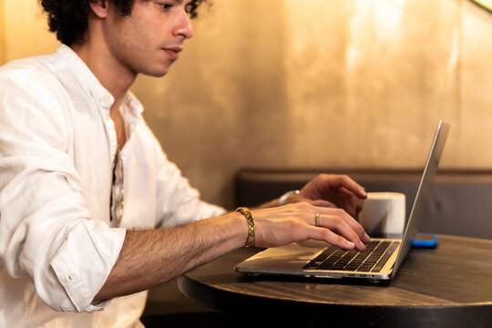Man use laptop at cafe table in city