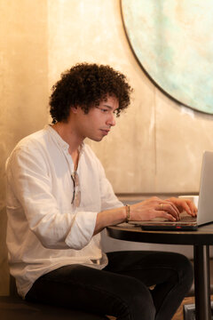 Man using laptop in a modern city cafe interior