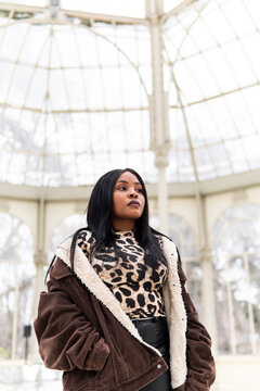 Black African woman in leopard print under glass dome