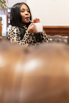 African woman drink coffee in a cozy coffee shop