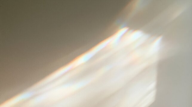 Soft prism rainbow light refraction on a pale neutral wall backdrop