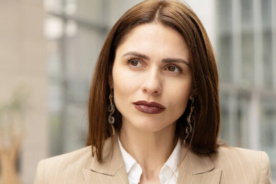 Confident businesswoman in office portrait with thoughtful gaze