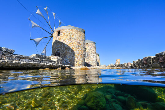 Half underwater image of historical windmills of Chios Island, Greece     