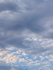 Obraz premium Layered Gray Clouds Opening to Bright Blue Sky with Soft Sunlight Creating a Hopeful Weather Scene