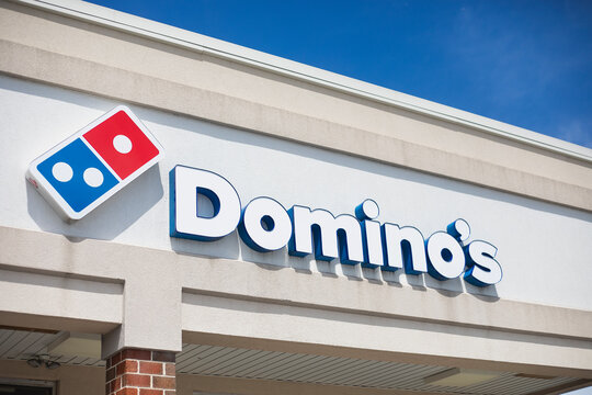 Domino's Pizza restaurant outdoor signage with the domino logo on the building facade against a blue sky in Philadelphia, Pennsylvania, USA, August 2, 2026