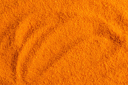 Close-up orange spice powder texture background for design