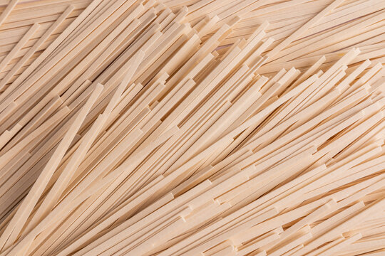 Close-up of uncooked pasta strips forming a textured background