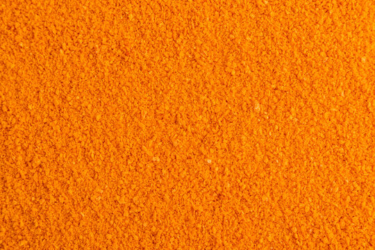 Orange powder texture background for spice and food design