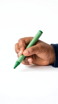 Dark-skinned hand holding a green marker pen upright against a clean white background with supplies stationery creative isolated