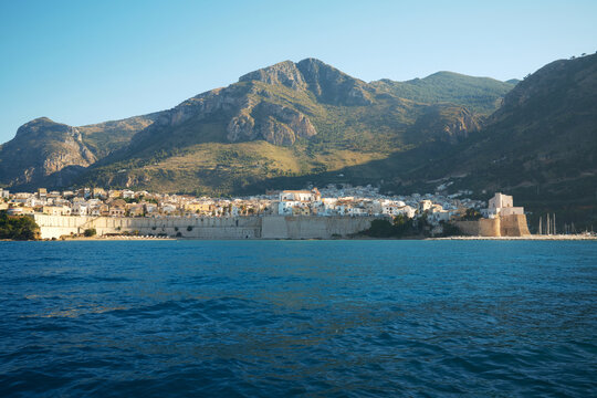 Coastal town beneath mountains on the Sicilian coast