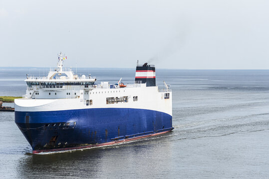 ow view of a roll-on roll-off cargo vessel entering a Gulf Coast port, showcasing commercial shipping and international freight transport.