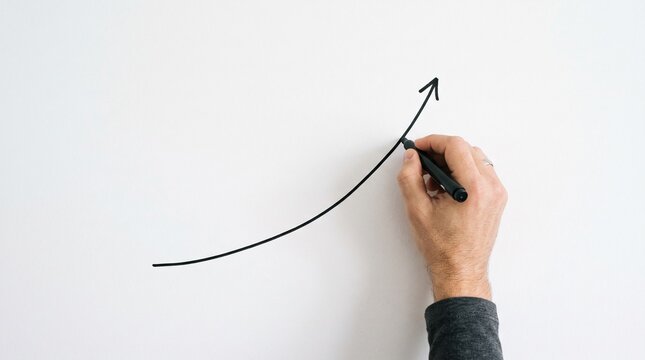Hand drawing an upward trending graph on a white background symbolizing growth and success