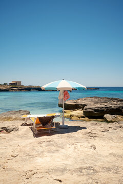Turquoise sea and beach umbrella on Favignana coast