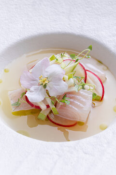 Peruvian fish ceviche with radish, cucumber and edible flower