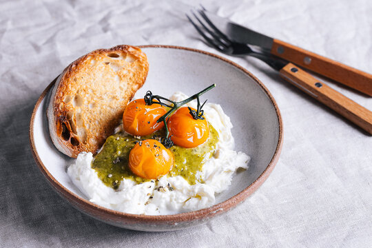 Caprese variation with burrata, baked tomato and pesto