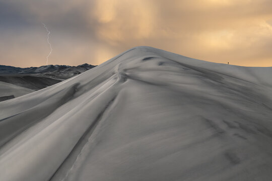 Lone traveler on Saujil Dunes in Catamarca, Argentina