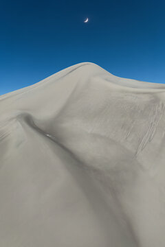 Saujil Dunes beneath crescent moon in Catamarca, Argentina