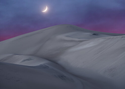 Crescent moon above Saujil Dunes in Catamarca, Argentina