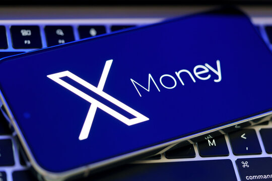 X Money branding and X logo shown in close up on a smartphone resting on a laptop keyboard. Stafford, United Kingdom, August 2, 2026.