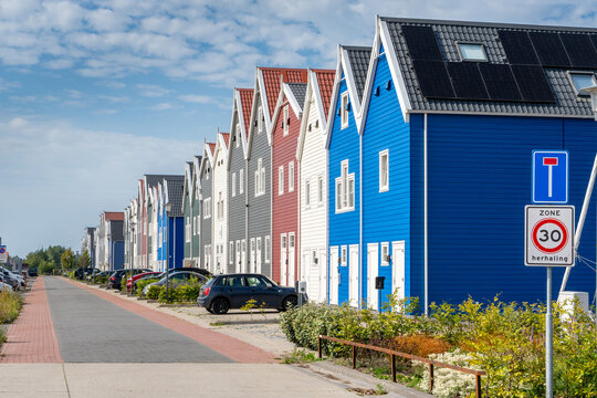 Colorful modern gabled houses along Strekdam street in the Waterfront district of Harderwijk, the Netherlands.