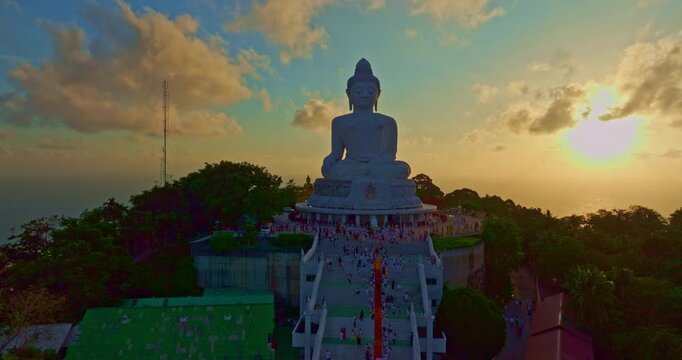 Aerial view of A group of 150 Buddhist monks on a Dhutanga pilgrimage arrives at Wat Phra Yai Big Buddha on mountain, Phuket, where hundreds of faithful devotees gather to offer alms and make merit.